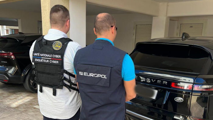 Europol and national cyber unit officers at the scene of an arrest during international fraud crackdown